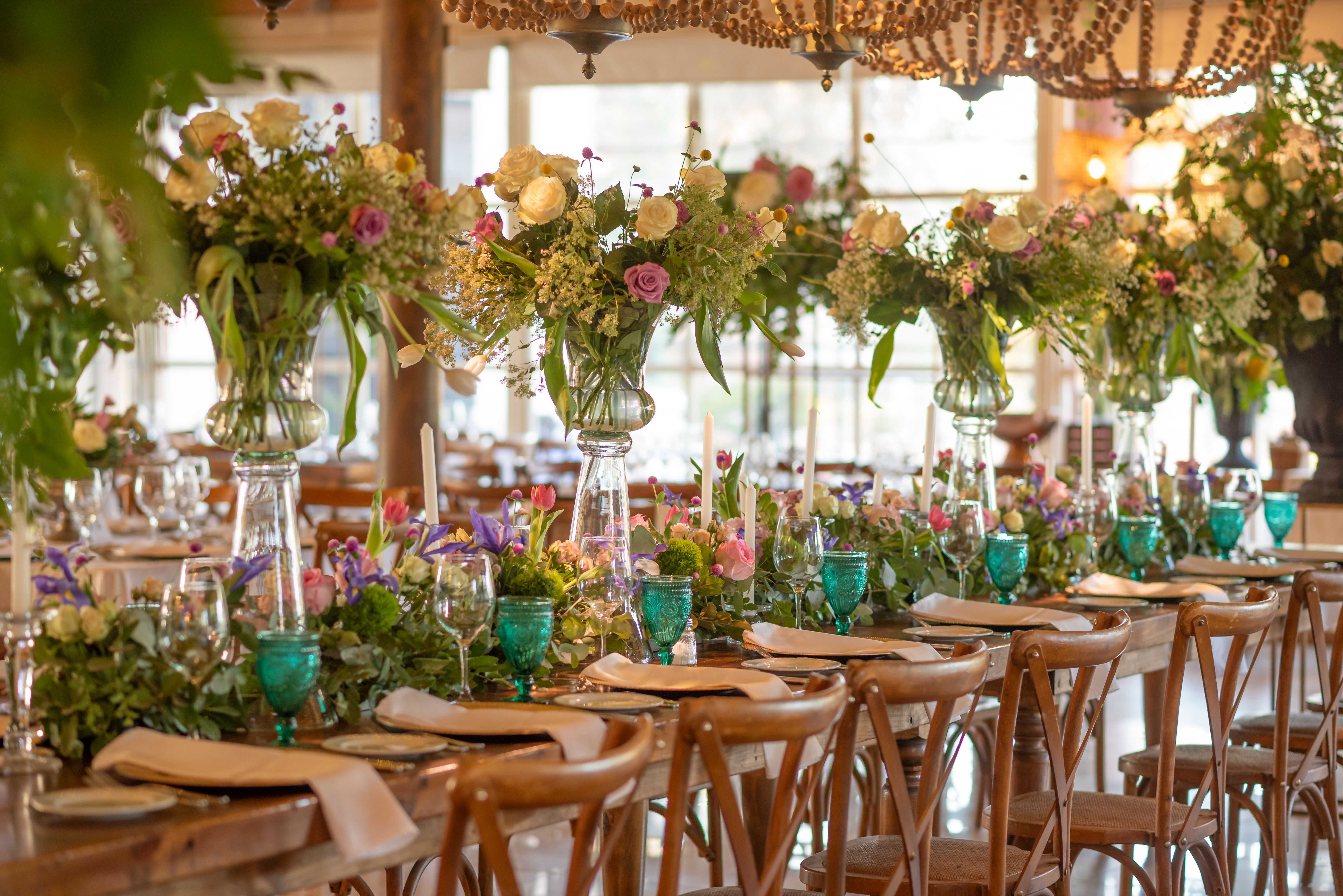 Elegant candlelit wedding reception tablescape with floral arrangements