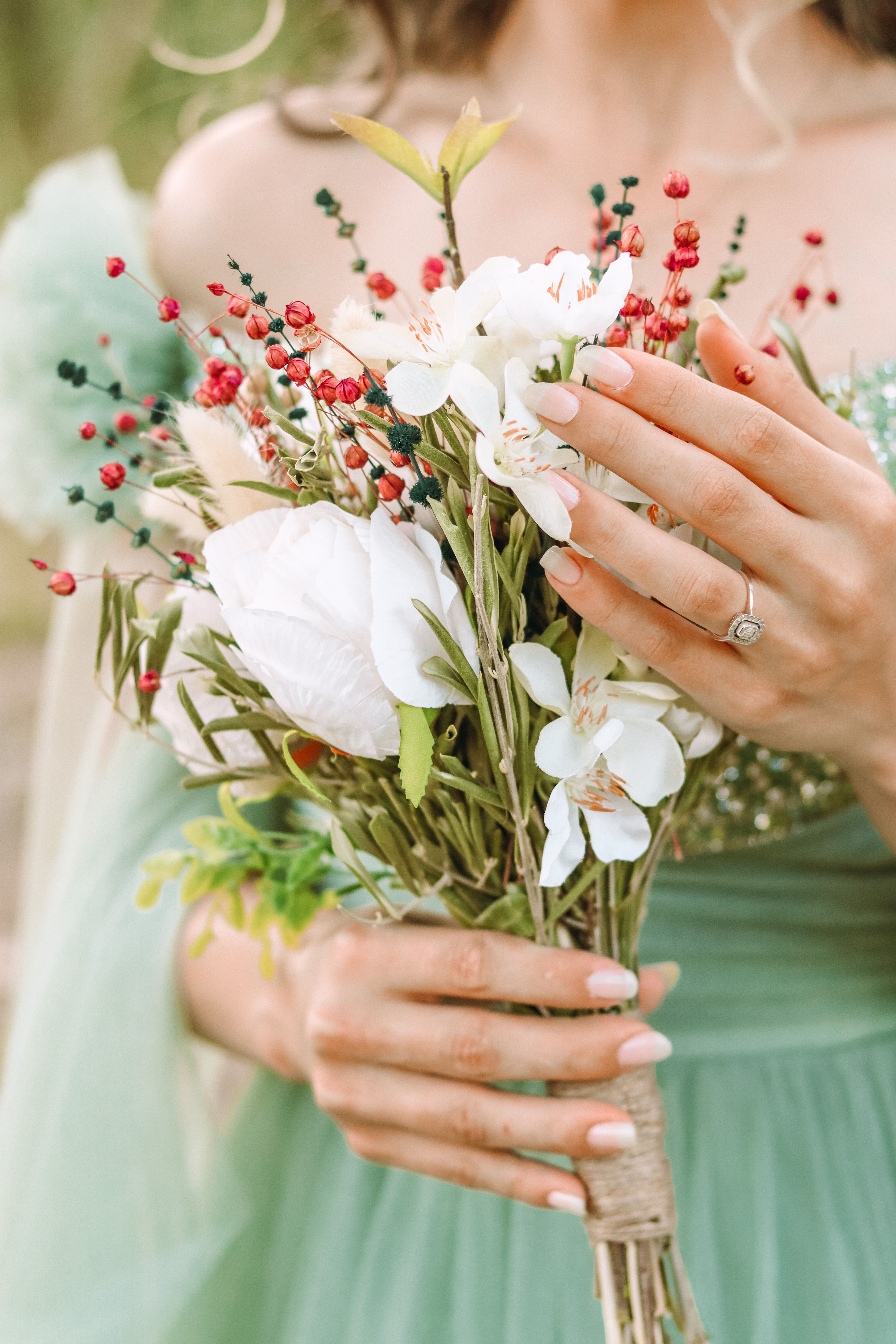 Hands arranging white flowers for a wedding display