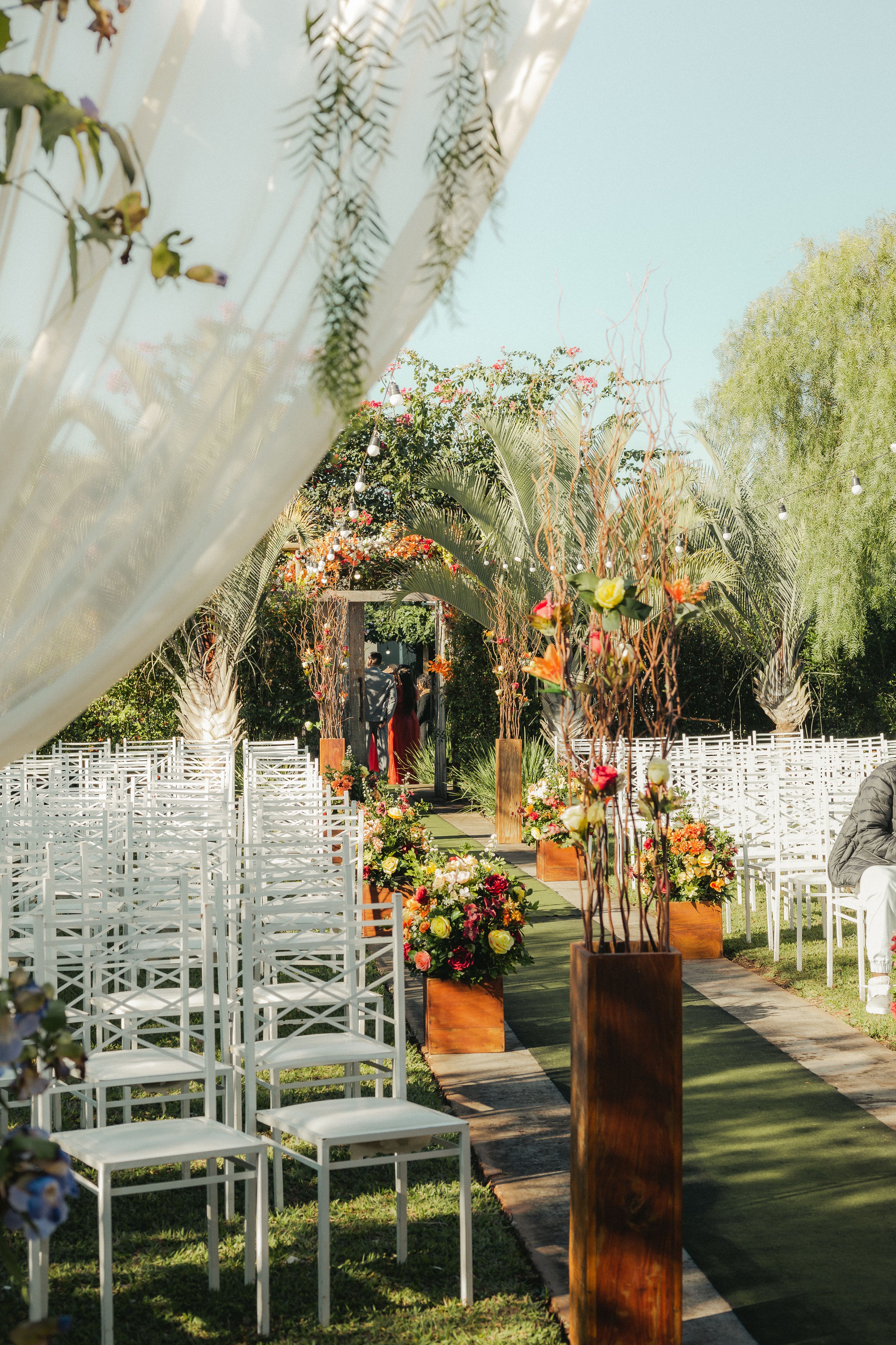 Flower-lined outdoor wedding ceremony aisle